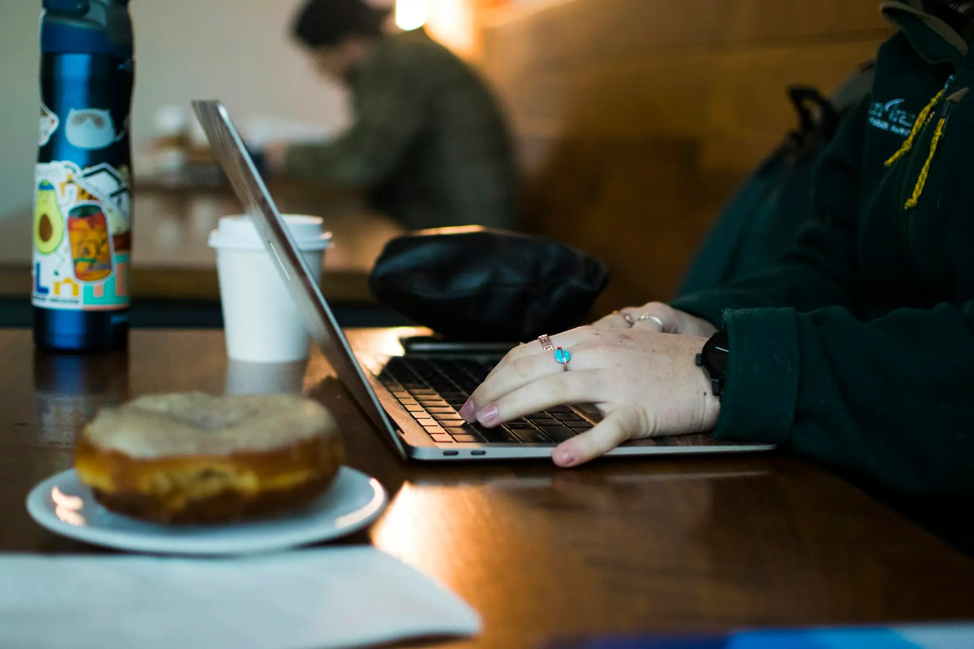Cafe owner working on a laptop late at night after closing