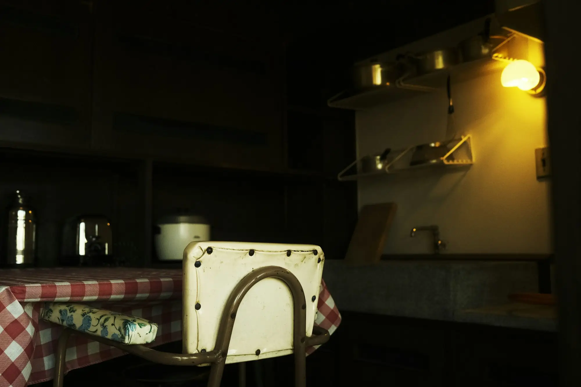 Kitchen table under a single light late at night