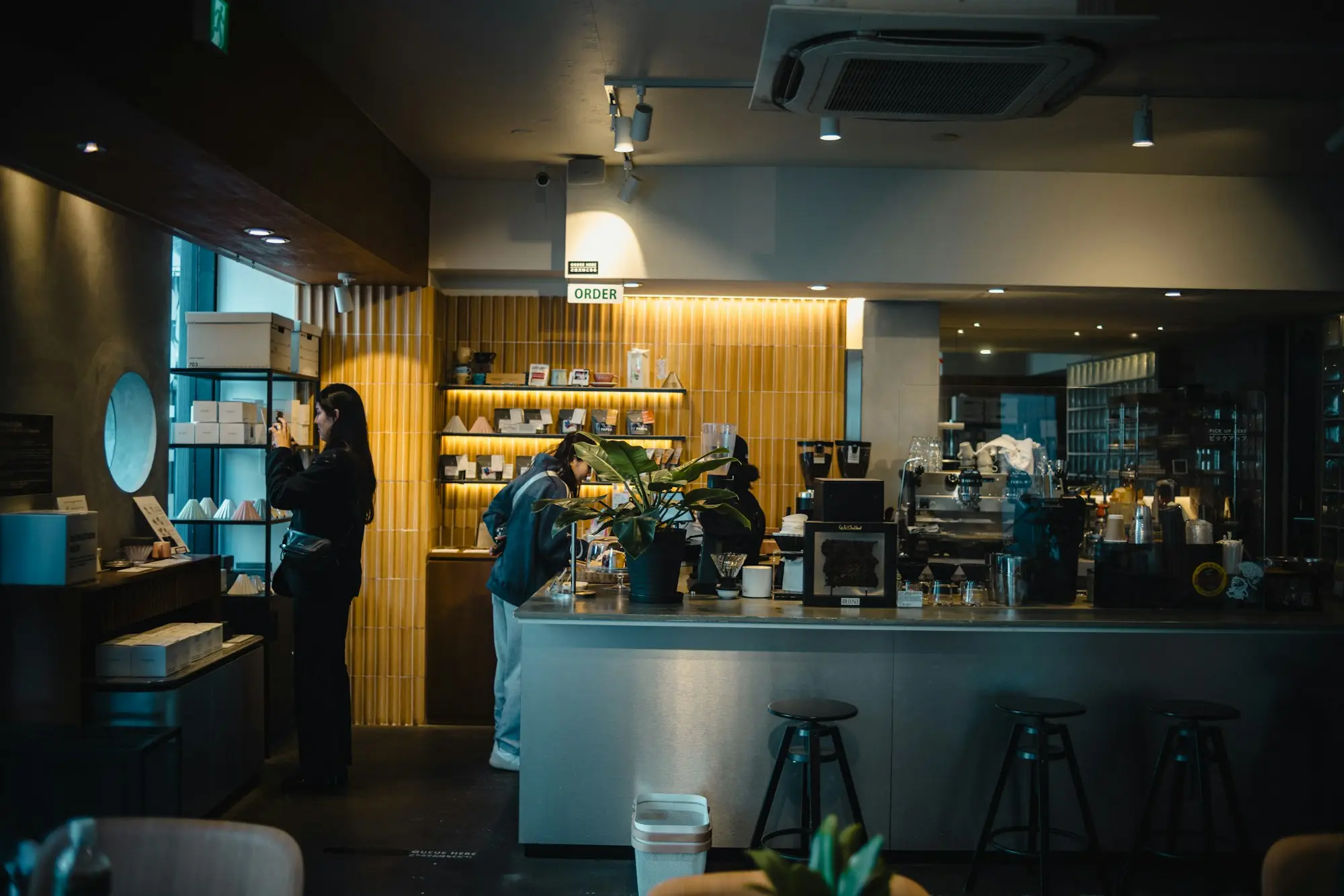 Cafe interior in the morning as the owner takes a phone call