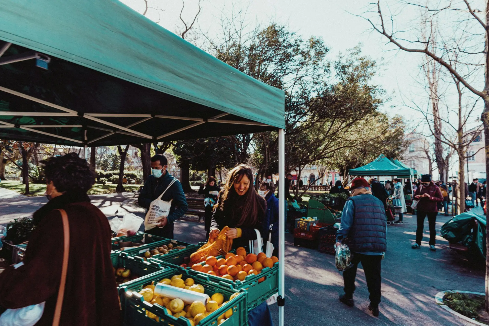 Stallholder serving customers at a weekend fruit and vegetable market